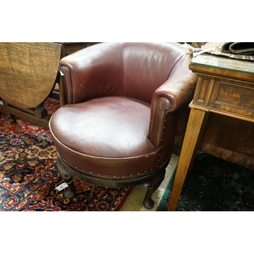 34 - A late Victorian mahogany burgundy leather tub frame swivel desk chair, width 72cm, depth 62cm, heig... 