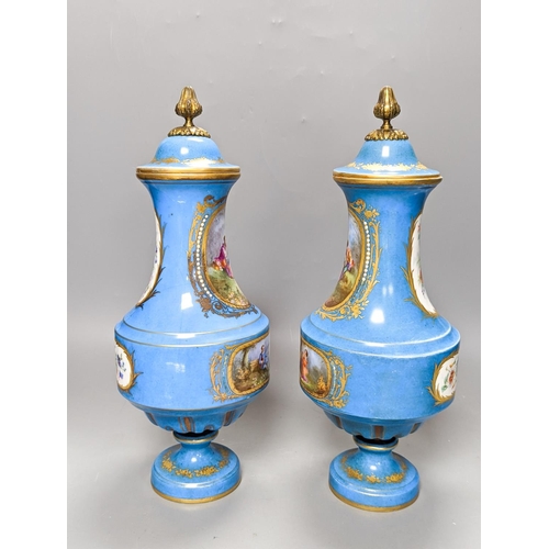 361 - A pair of Sevres style porcelain bleu celeste ground vases and covers, 34cm