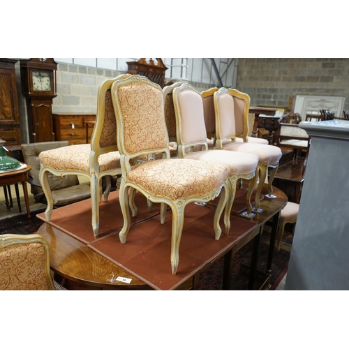 39 - A set of fourteen French Louis XV style painted upholstered dining chairs with loose covers... 