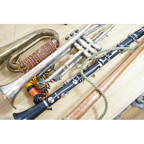 393 - A Boosey and co Clarinet H.75983, plated trumpet, brass bugle and a copper hunting horn 87cm... 