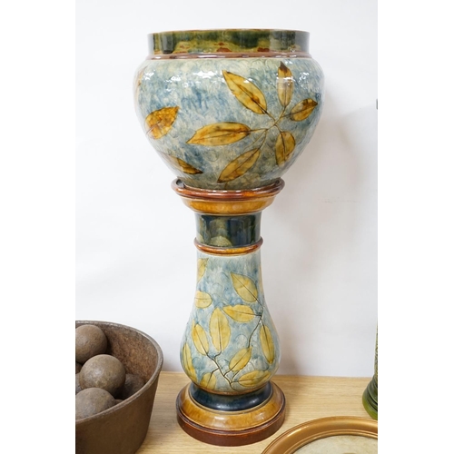 398 - A Doulton, Lambeth Autumnal leaves jardinière on stand, 73cm high and a Burmantofts green glazed sto... 