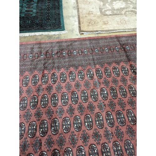 40 - A pink ground Bokhara carpet, 315 x 220cm