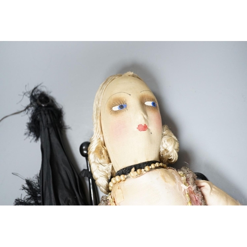 406 - A boudoir doll circa 1920's and a black parasol