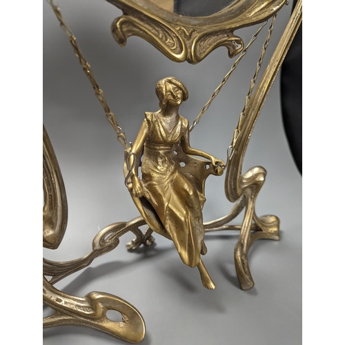 409 - An Art Nouveau style mirror with model of girl sitting on a swing, height 45cm