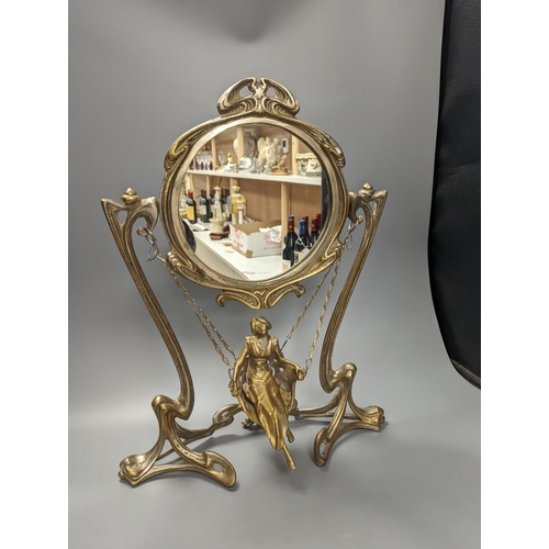 409 - An Art Nouveau style mirror with model of girl sitting on a swing, height 45cm