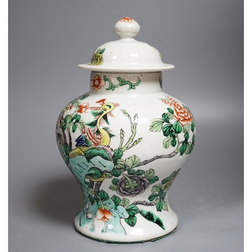 437 - A Chinese Famille-Verte jar and cover decorated with Phoenix and flowers, 26cm