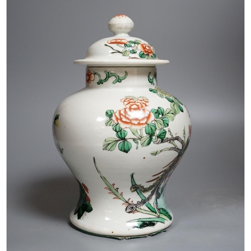 437 - A Chinese Famille-Verte jar and cover decorated with Phoenix and flowers, 26cm