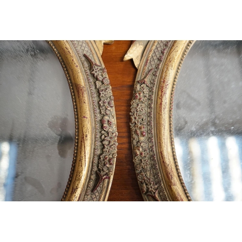 54 - A pair of Victorian style oval gilt framed wall mirrors, width 37cm, height 52cm