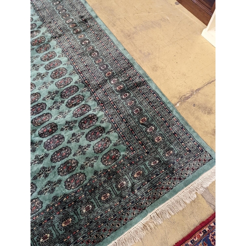 64 - A Bokhara green ground carpet, 282 x 184cm