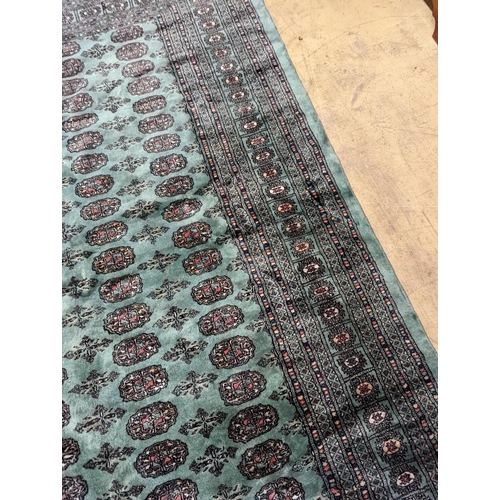 64 - A Bokhara green ground carpet, 282 x 184cm