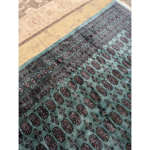 64 - A Bokhara green ground carpet, 282 x 184cm