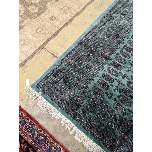 64 - A Bokhara green ground carpet, 282 x 184cm