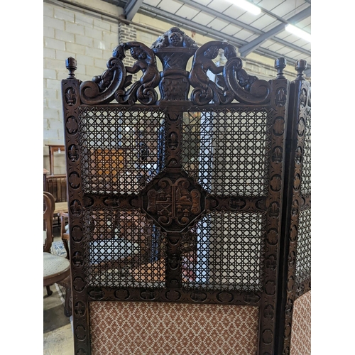 8 - A 1920's Carolean style oak and cane work two fold dressing screen, each panel width 60cm, height 18... 