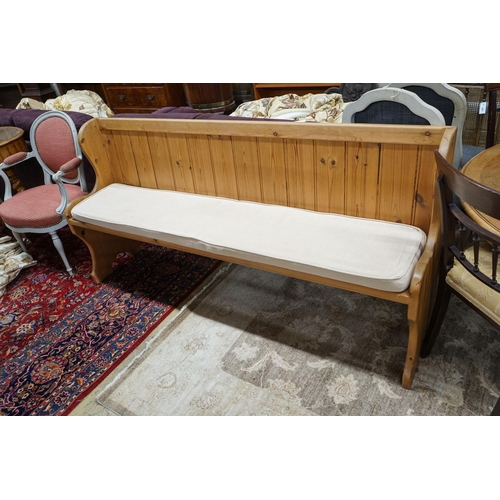 82 - A Victorian style pitch pine pew with cushion seat, length 187cm, depth 40cm, height 88cm... 