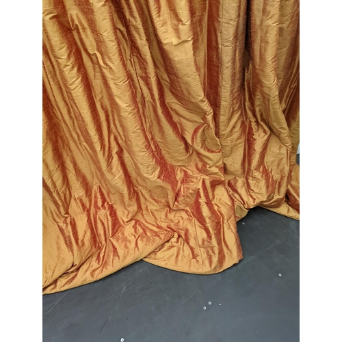 86 - A pair of orange lined curtains. Approximate measurements: Width of top 180cm, Width of bottom 320cm... 