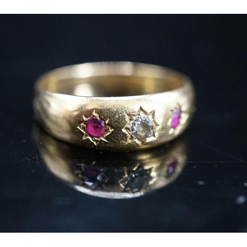 968 - An early 20th century yellow metal and gypsy set ruby and diamond set three stone ring, size O, gros... 