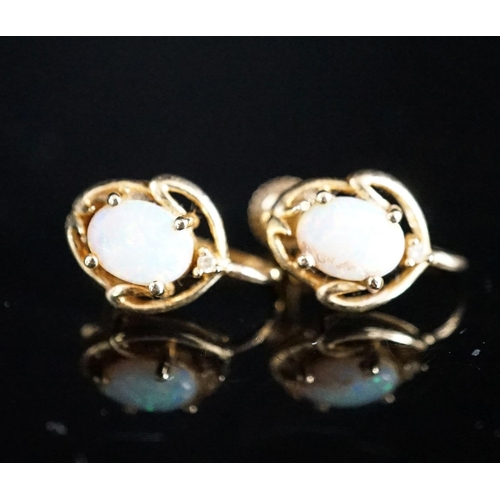 969 - A modern pair of 585 yellow metal and oval white opal set ear clips, 12mm, gross weight 3.2 grams.... 