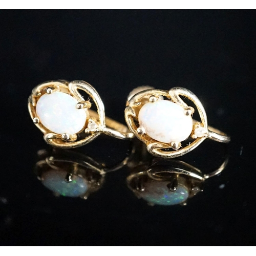 969 - A modern pair of 585 yellow metal and oval white opal set ear clips, 12mm, gross weight 3.2 grams.... 