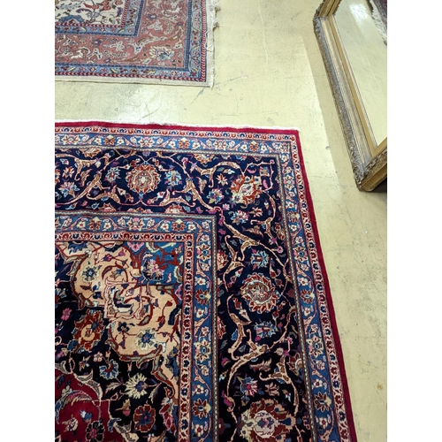 99 - A Kashan burgundy ground carpet, 380 x 300cm