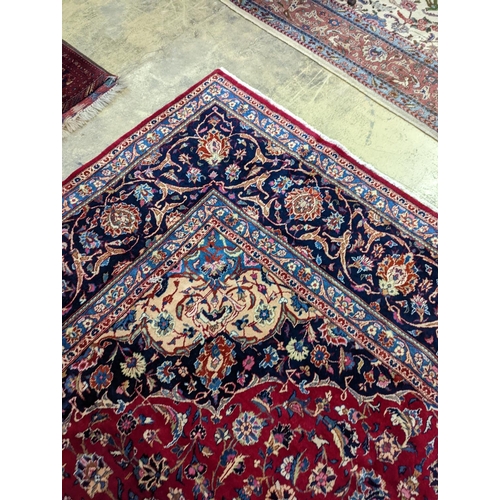 99 - A Kashan burgundy ground carpet, 380 x 300cm