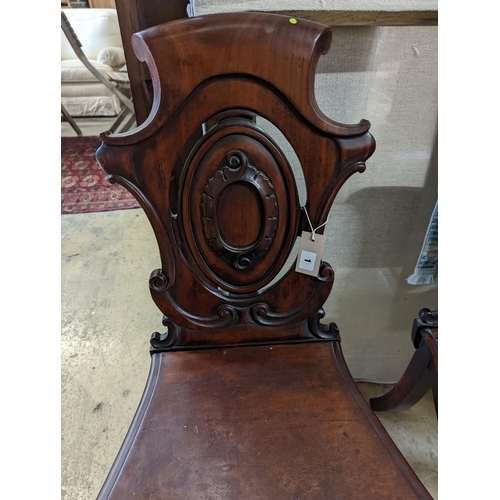 1 - A pair of Victorian carved mahogany hall chairs, a.f.