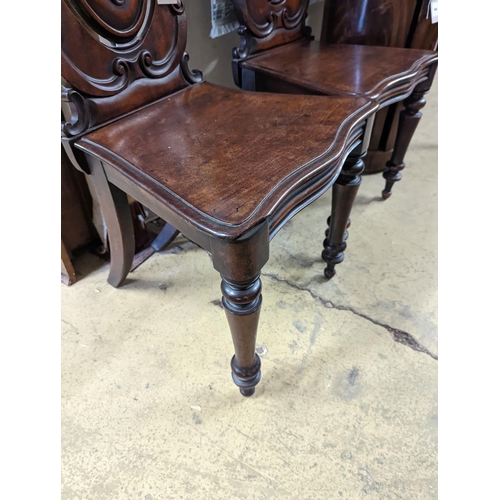 1 - A pair of Victorian carved mahogany hall chairs, a.f.