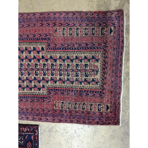 100 - A Bokhara red ground rug and a Belouch prayer rug, larger 144 x 88cm