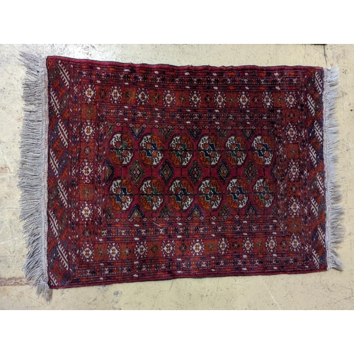 100 - A Bokhara red ground rug and a Belouch prayer rug, larger 144 x 88cm