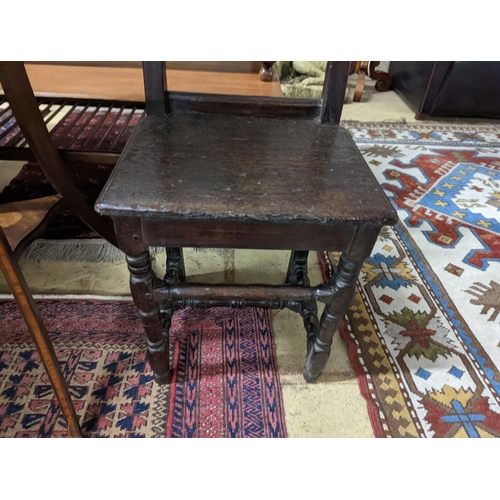 102 - A 17th century style Continental oak back stool, width 40cm, depth 34cm, height 102cm