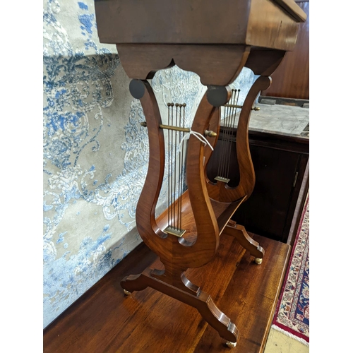 11 - A reproduction Regency style mahogany work table on lyre supports, width 39cm, depth 27cm, height 69... 