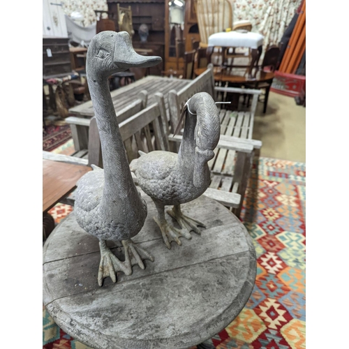 111 - A pair of cast metal garden ornaments modelled as geese, larger height 51cm