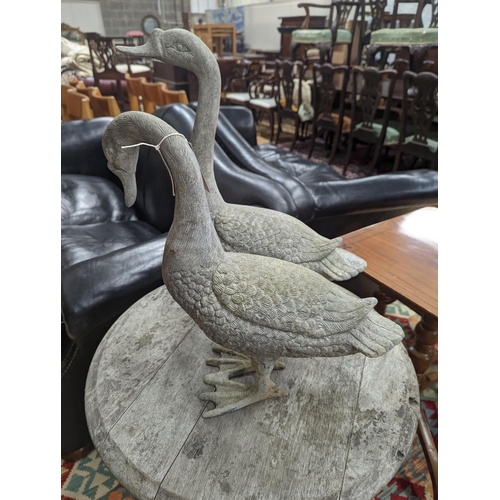 111 - A pair of cast metal garden ornaments modelled as geese, larger height 51cm