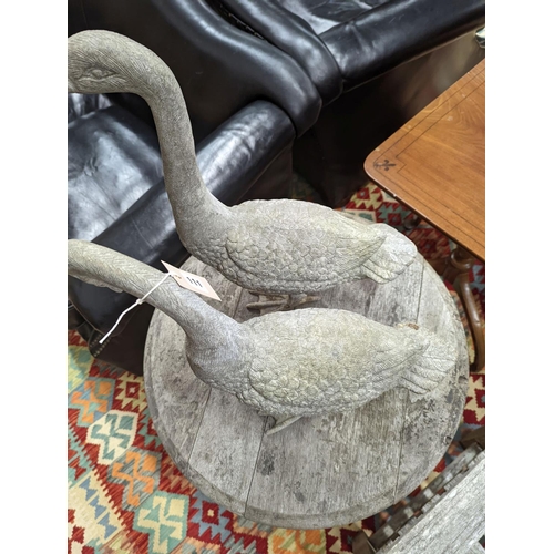 111 - A pair of cast metal garden ornaments modelled as geese, larger height 51cm