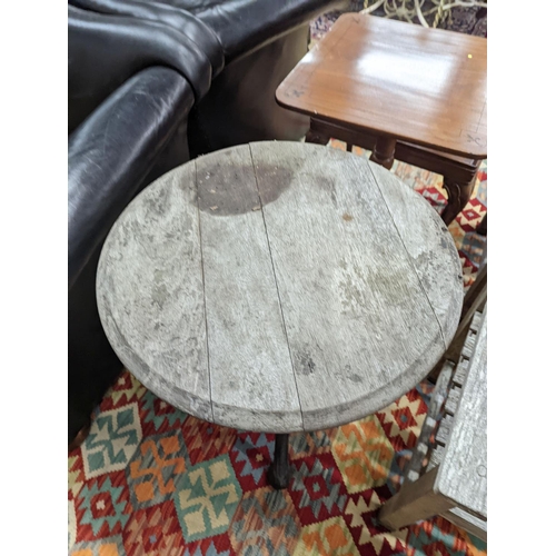 112 - A Victorian cast iron Britannia table with circular weathered wood top, diameter 58cm, height 69cm... 