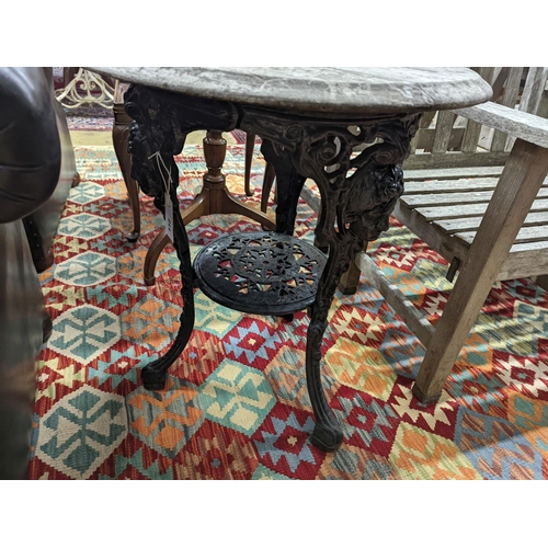 112 - A Victorian cast iron Britannia table with circular weathered wood top, diameter 58cm, height 69cm... 