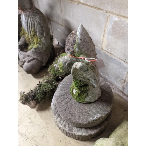 145 - Two small circular mill stones, a reconstituted stone gargoyle and a terracotta reclining pixie gard... 