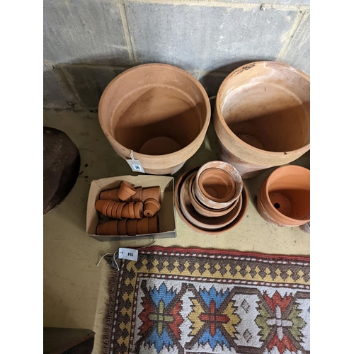 153 - A collection of approximately 40 assorted terracotta planters, largest diameter 32cm