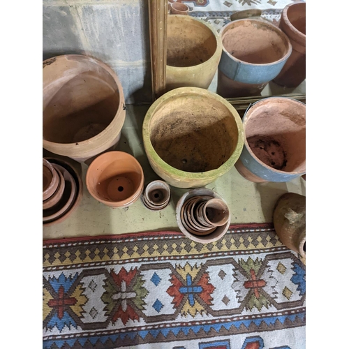 153 - A collection of approximately 40 assorted terracotta planters, largest diameter 32cm