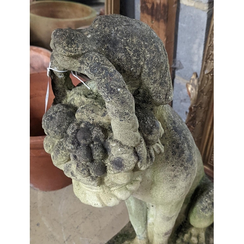 158 - A reconstituted stone garden ornament of a seated hound, a basket of fruit in its mouth, height 60cm... 