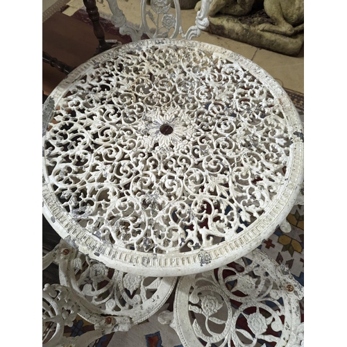 165 - A Victorian style painted aluminium circular garden table, diameter 72cm, together with four chairs... 