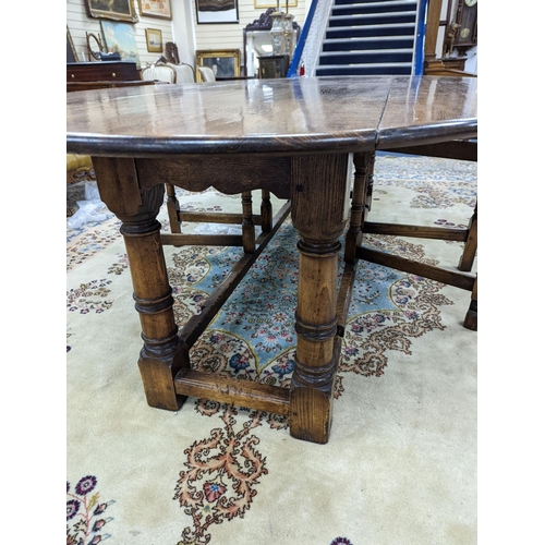 175 - An 18th century style oak gateleg wake table, length 250cm, width 154cm extended, height 75cm... 