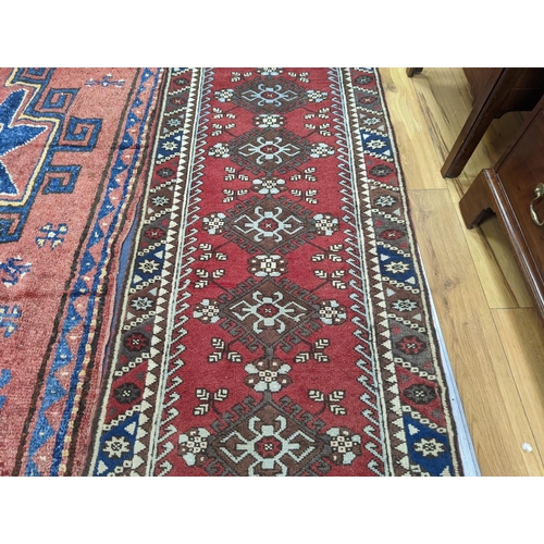 201 - A Caucasian design red ground runner, 300 x 78cm