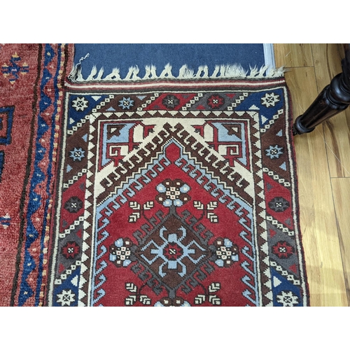 201 - A Caucasian design red ground runner, 300 x 78cm