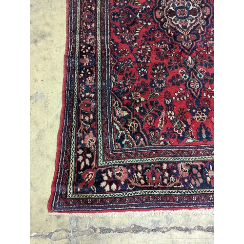 21 - A Tabriz style red ground carpet, 290 x 190cm