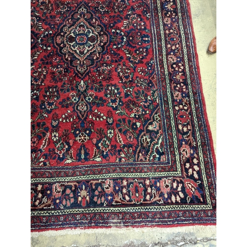 21 - A Tabriz style red ground carpet, 290 x 190cm