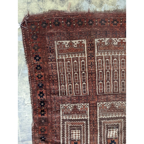 22 - An Afghan red ground prayer rug, 166 x 120cm