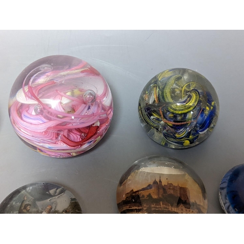 255 - Nine various glass paperweights