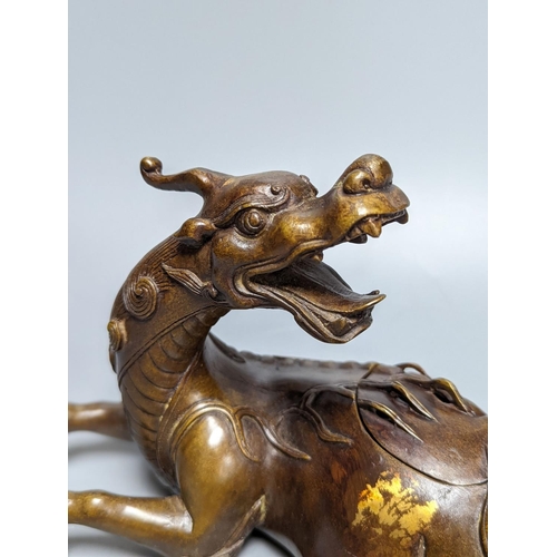 262 - A Chinese parcel-gilt bronze incense burner and cover, modelled as a recumbent qilin, Qing dynasty, ... 