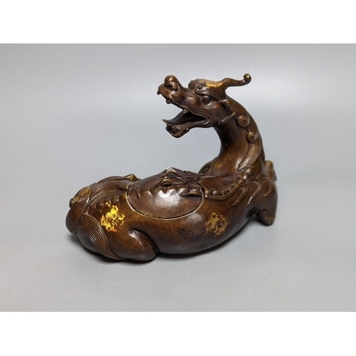 262 - A Chinese parcel-gilt bronze incense burner and cover, modelled as a recumbent qilin, Qing dynasty, ... 