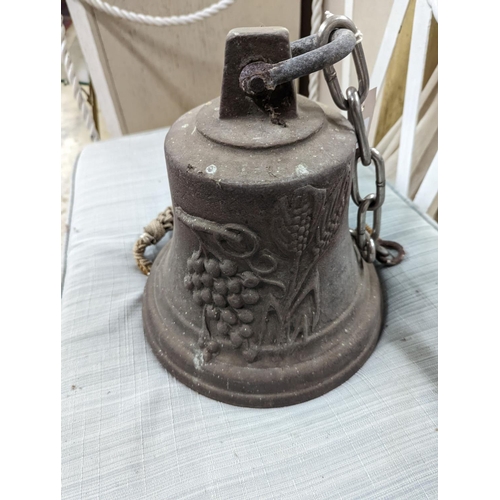 27 - A cast metal bell moulded with deer and fruit, height 24cm